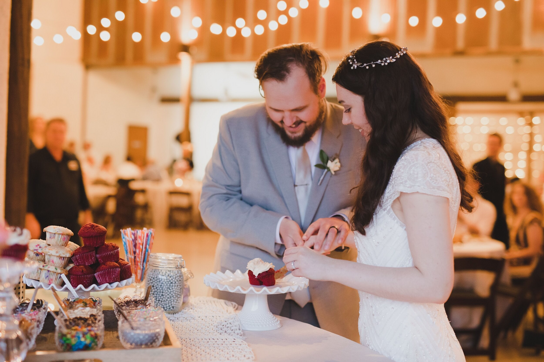 Bride and groom enjoy a custom cupcake at their Austin, Texas wedding