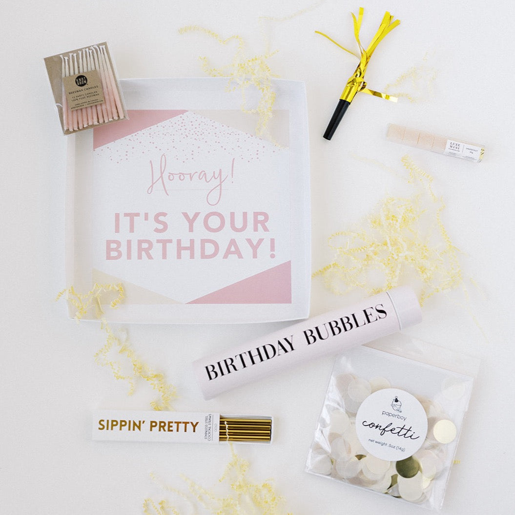 Birthdays are THE BEST! Help your loved one celebrate their special day the right way with a proper party-in-a-box. (BTW: Did you know that blowing out candles on a cupcake increases the chances of your bday wish coming true? Well, that’s what our research shows, anyway. 😉)  Gift Contains:  Pack of Champagne-colored confetti “Birthday Bubbles” Slim Flask Bottle Glitter champagne cubes Gold stainless steel cocktail straws Pack of 12 hand-dipped beeswax candles Party horn