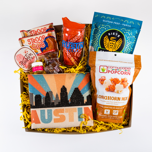 Austin themed Gift Basket for pickup and delivery in Austin Texas. Contains items from The Cupcake Bar, Stroop Club, Siete, Cornucopia Popcorn, Lammes Candies, Pride Socks, and more.